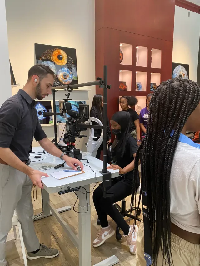 Students viewing their iris artwork on screen